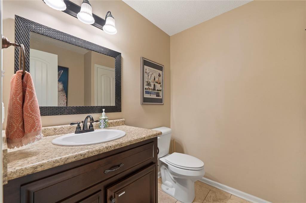 121 Little Riverview Road Eatonton, GA 31024 - Photo 39 of 53 a bathroom with a granite countertop sink mirror vanity and toilet