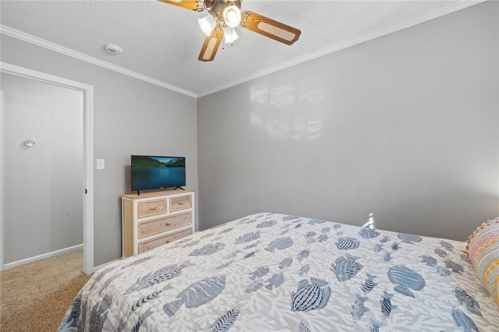 121 Little Riverview Road Eatonton, GA 31024 - Photo 41 of 53 a bedroom with a bed and a flat screen tv