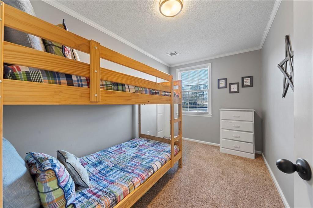 121 Little Riverview Road Eatonton, GA 31024 - Photo 42 of 53 a bedroom with a bed and a cabinet