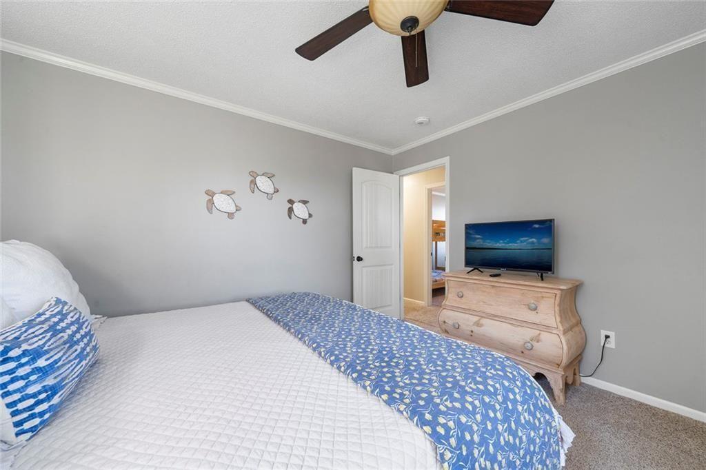 121 Little Riverview Road Eatonton, GA 31024 - Photo 45 of 53 a bedroom with a bed and a flat screen tv