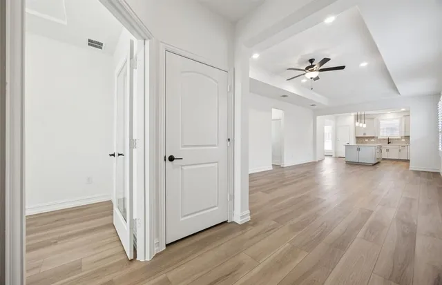 a view of a room with wooden floor and a window