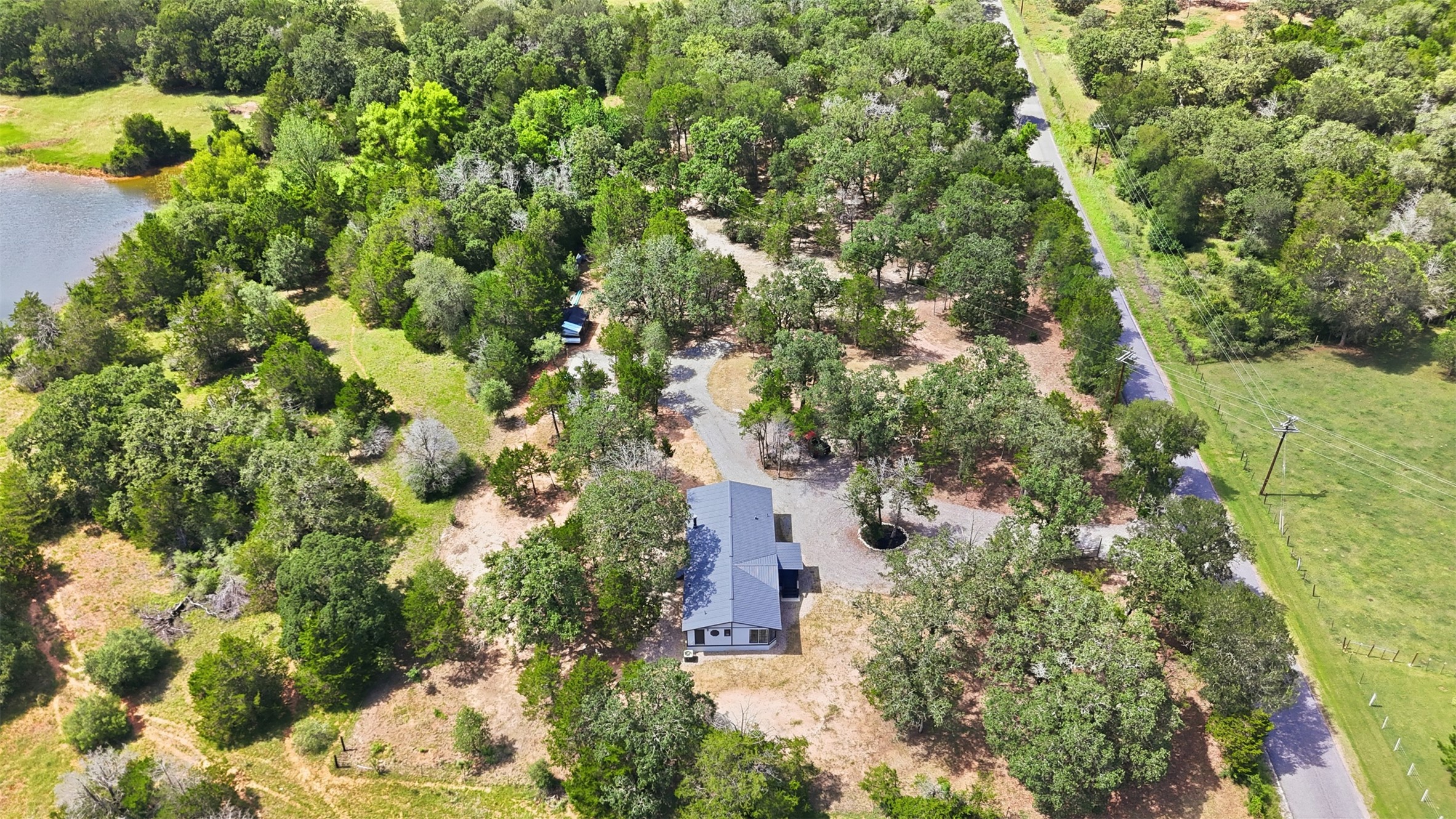 154 Antioch Road Smithville, TX 78957 - Photo 27 of 32 Discover a private retreat nestled among a verdant landscape. *Pond is not part of this property*
