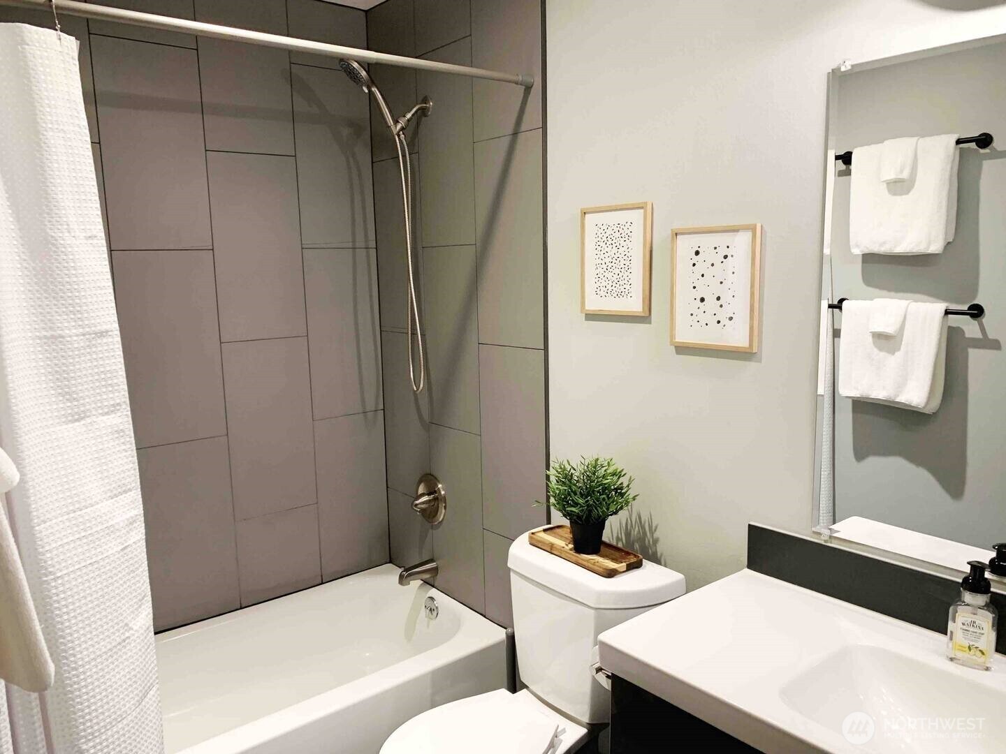 213 1st Avenue South Seattle, WA 98104 - Photo 12 of 17 a bathroom with a sink toilet and shower