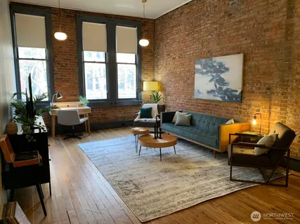 a view of a dining room with furniture and a rug