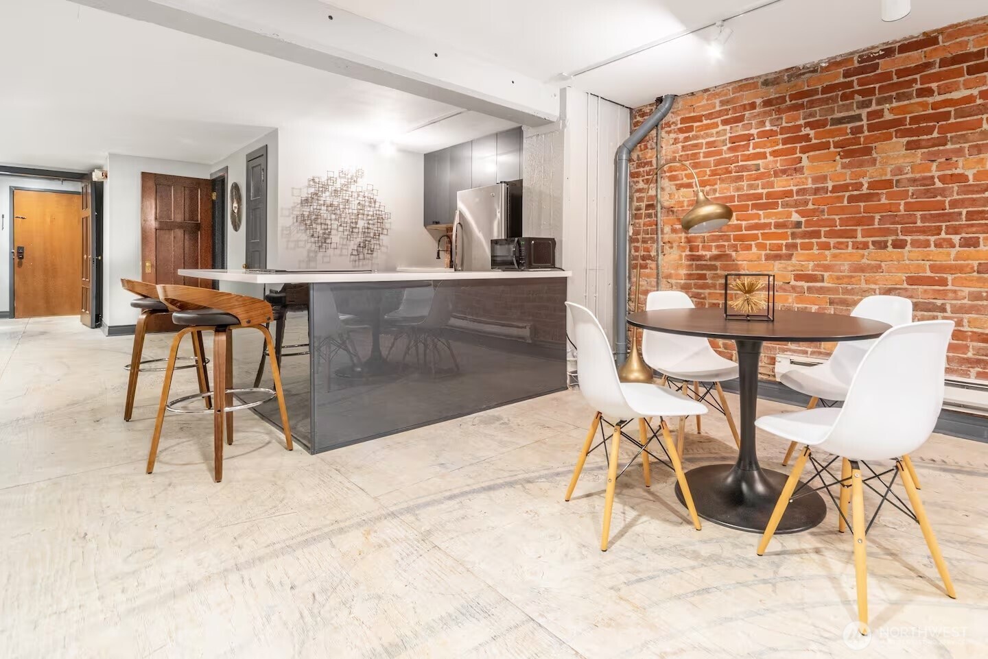 213 1st Avenue South Seattle, WA 98104 - Photo 6 of 17 a view of a dining room with furniture and a rug