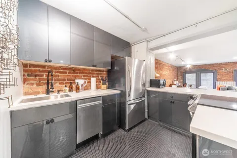 a kitchen with a sink refrigerator and cabinets