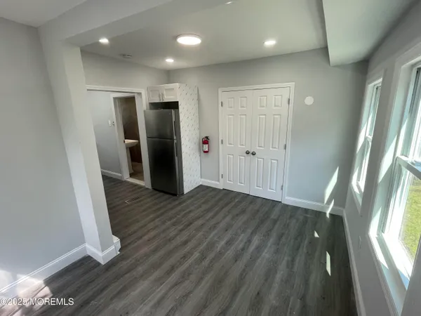 a view of hallway with wooden floor and window