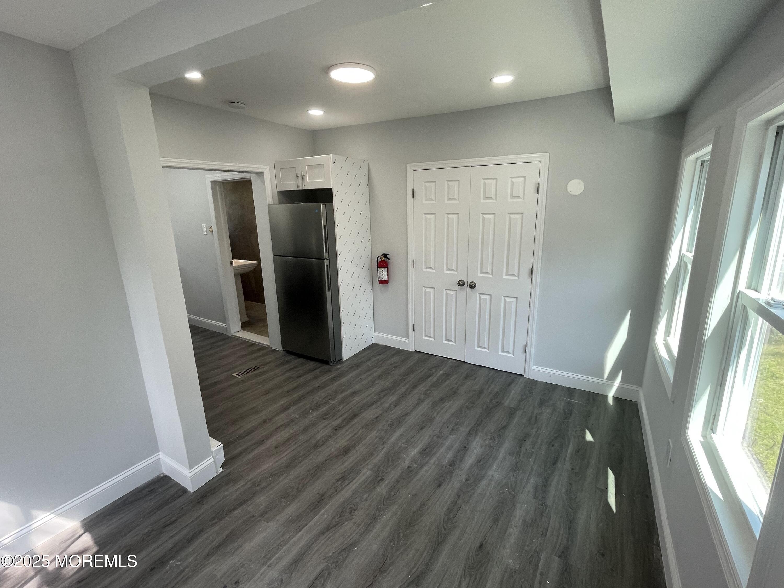 413 Ridge Avenue, Unit 3 Asbury Park, NJ 07712 - Photo 2 of 7 a view of hallway with wooden floor and window