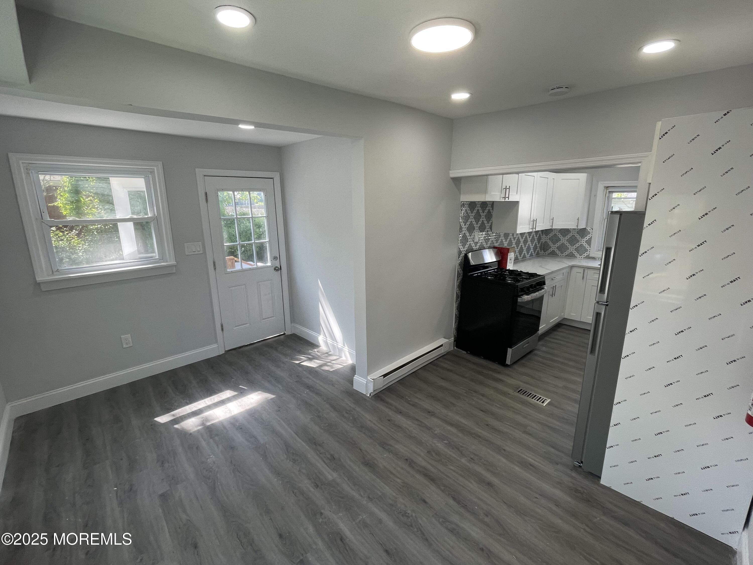 413 Ridge Avenue, Unit 3 Asbury Park, NJ 07712 - Photo 3 of 7 a view of livingroom with hardwood floor and a window