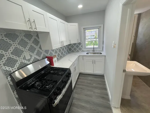 a kitchen with sink and cabinets