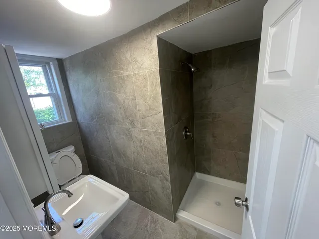 a bathroom with a toilet and a shower