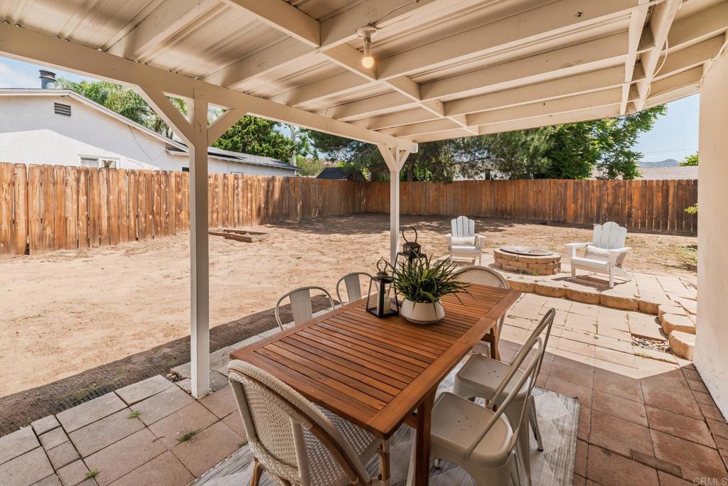 13425 Standish Drive Poway, CA 92064 - Photo 26 of 34 a view of a patio with a table chairs and wooden fence