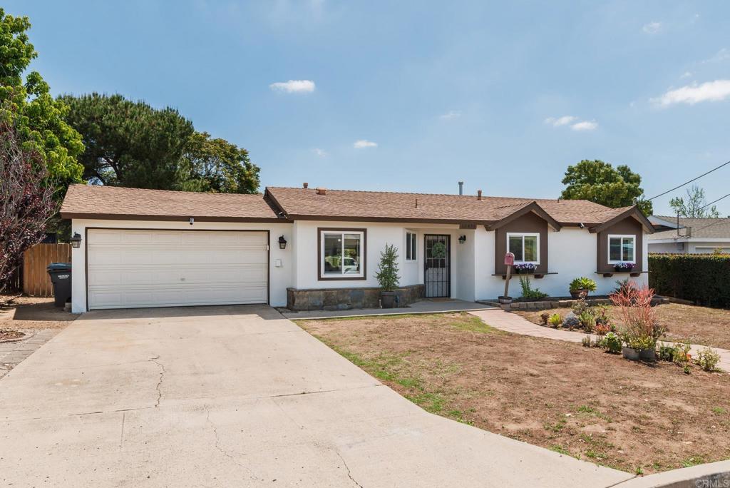 13425 Standish Drive Poway, CA 92064 - Photo 4 of 34 a front view of a house with a yard and garage
