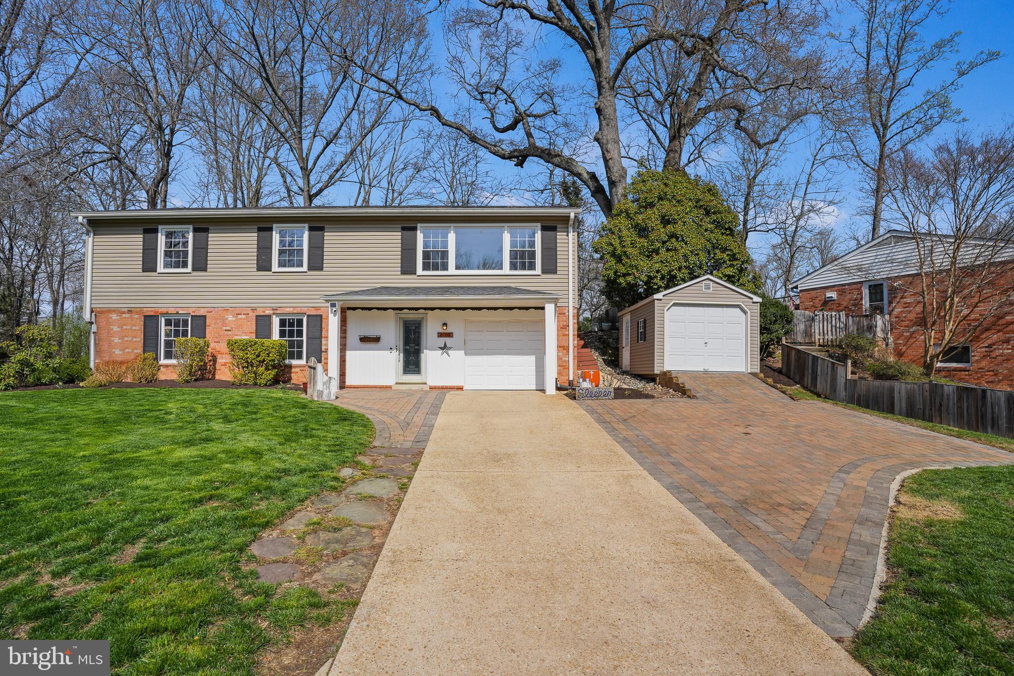 6708 Portree Court Springfield, VA 22152 - Photo 1 of 37 a front view of a house with a garden and trees