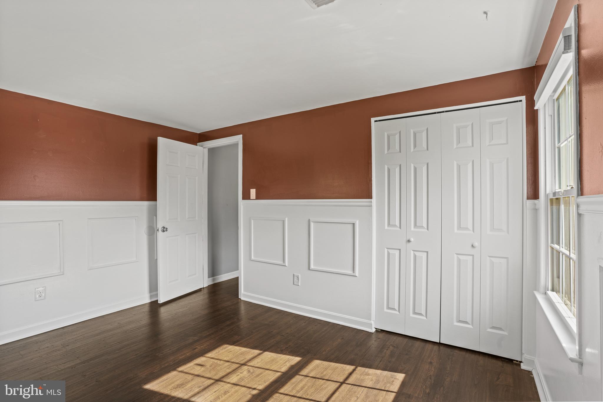 6708 Portree Court Springfield, VA 22152 - Photo 20 of 37 an empty room with wooden floor and windows