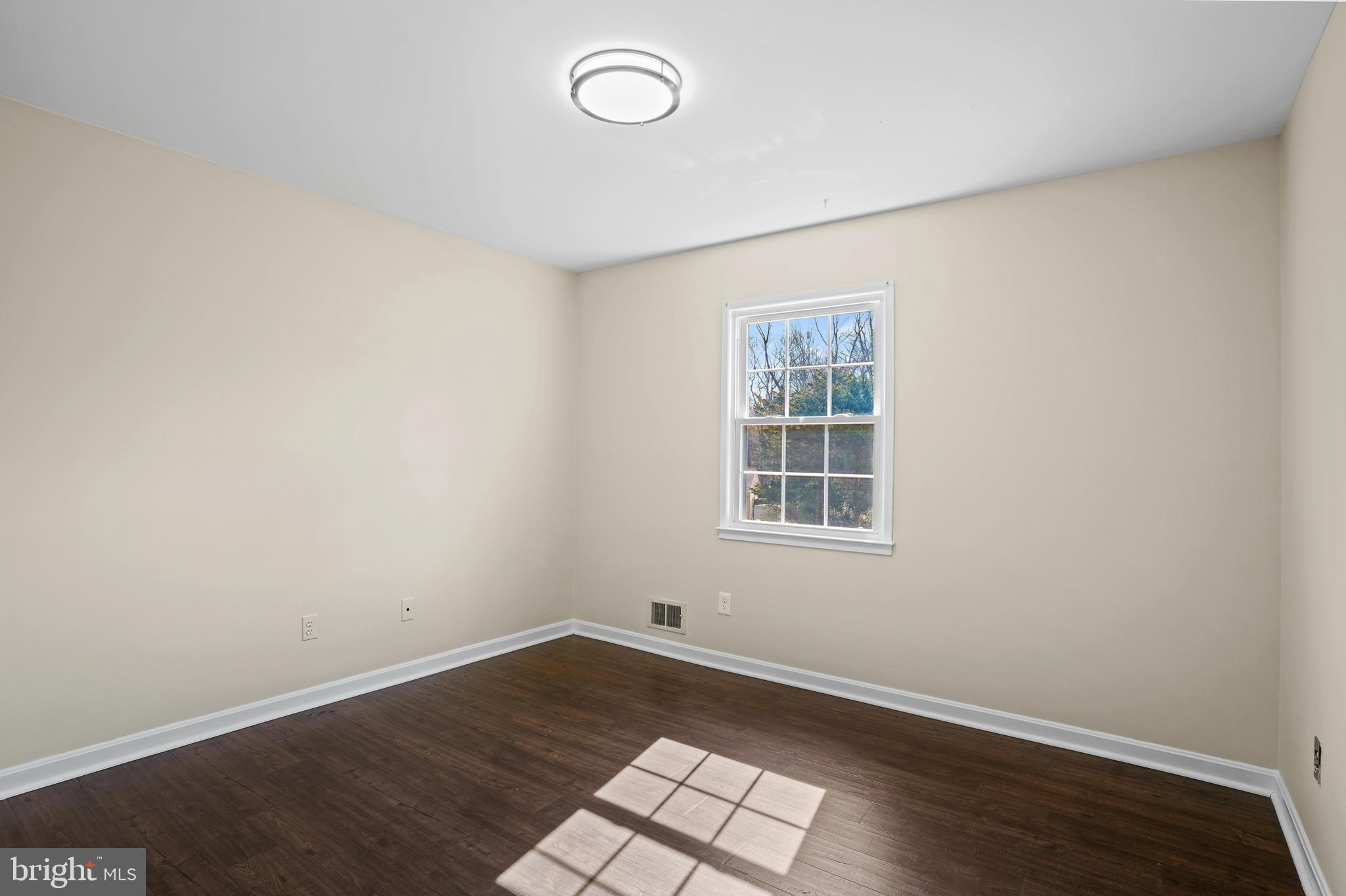 6708 Portree Court Springfield, VA 22152 - Photo 21 of 37 an empty room with wooden floor and windows