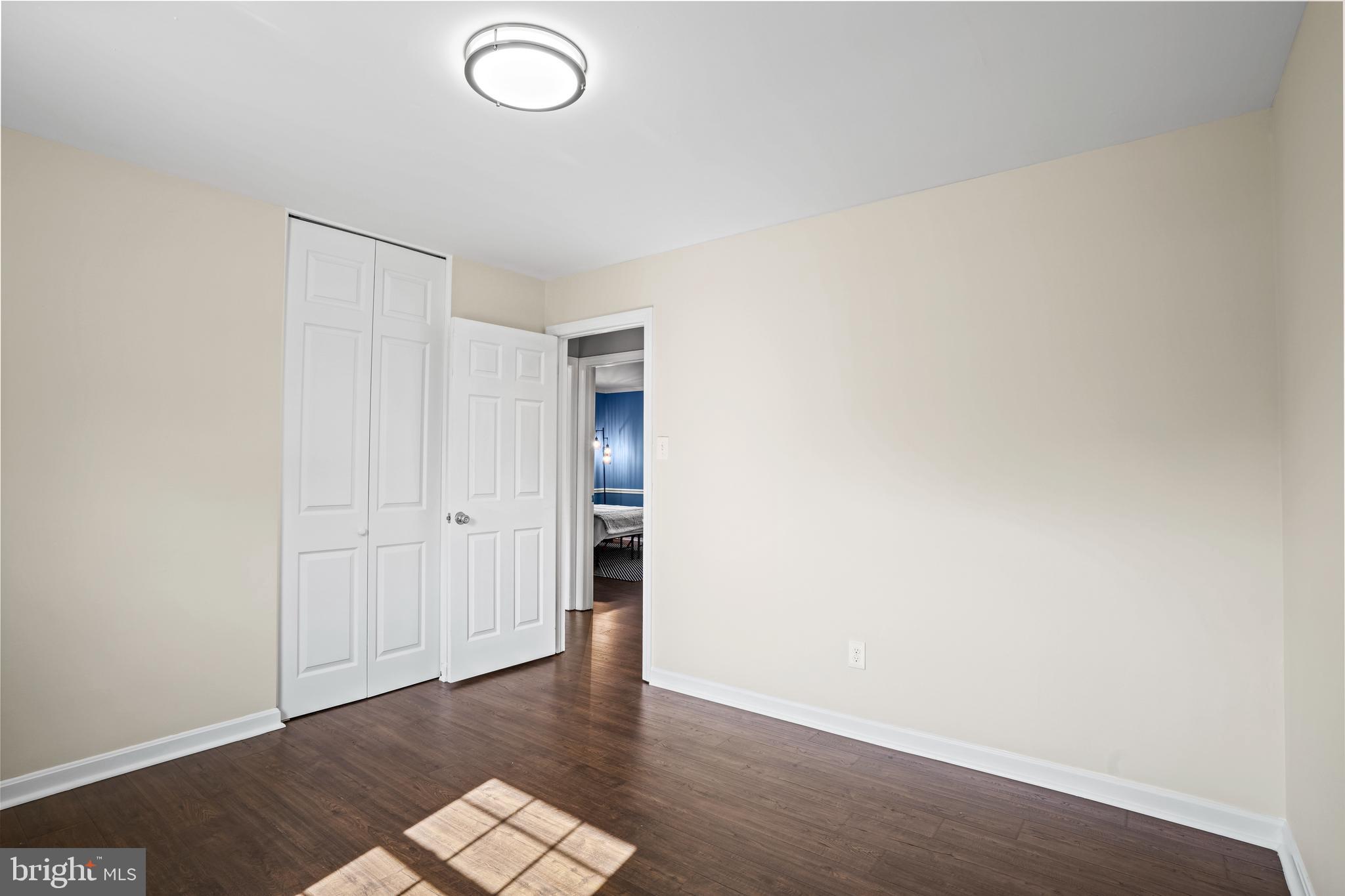 6708 Portree Court Springfield, VA 22152 - Photo 22 of 37 an empty room with wooden floor and natural light