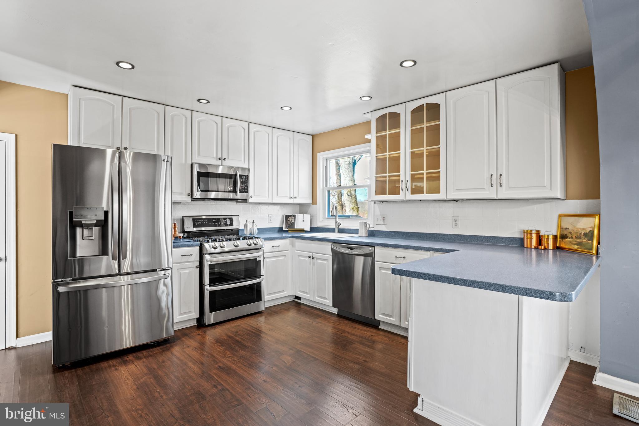 6708 Portree Court Springfield, VA 22152 - Photo 3 of 37 a kitchen with wooden cabinets and stainless steel appliances