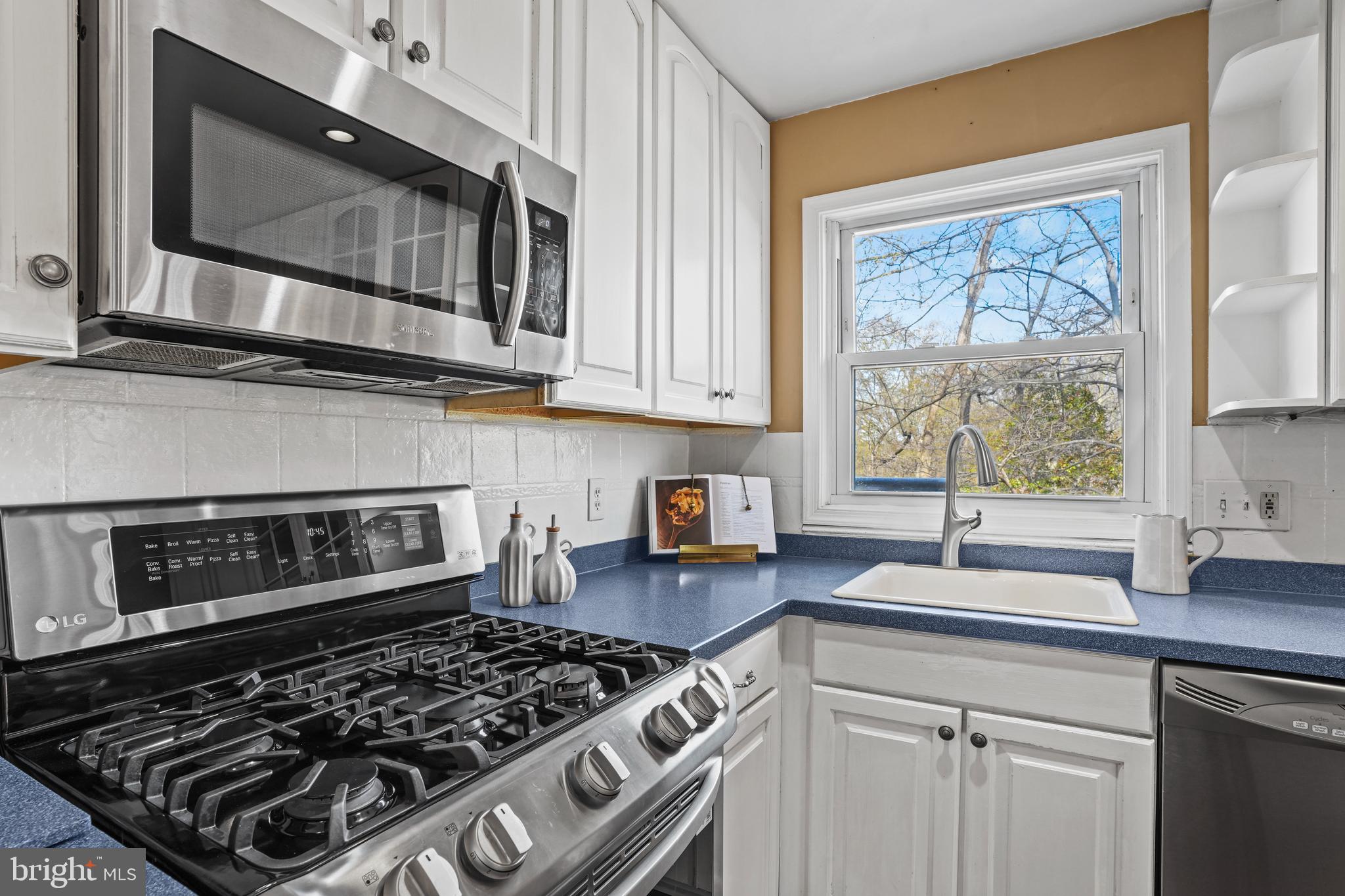 6708 Portree Court Springfield, VA 22152 - Photo 5 of 37 a kitchen with stainless steel appliances a stove a sink a microwave and cabinets