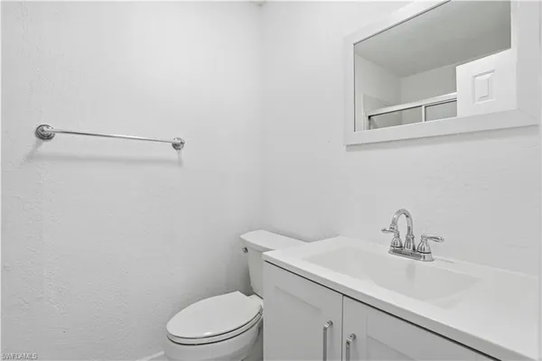 a bathroom with a sink a toilet and vanity