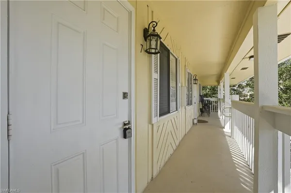 a view of a hallway with a livingroom and furniture