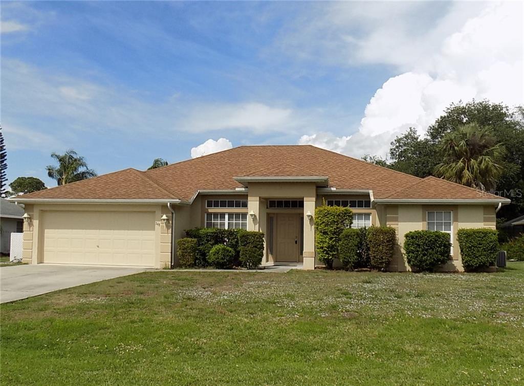 348 Maraca Street Punta Gorda, FL 33983 - Photo 1 of 1 a front view of a house with a garden