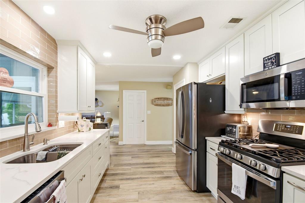 2636 Talbot Road Fern Park, FL 32730 - Photo 13 of 47 a kitchen with stainless steel appliances a stove a sink and a refrigerator