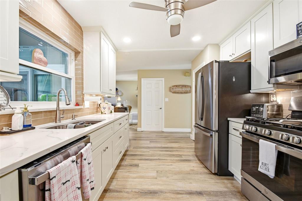 2636 Talbot Road Fern Park, FL 32730 - Photo 14 of 47 a large kitchen with stainless steel appliances granite countertop a refrigerator a stove and a sink