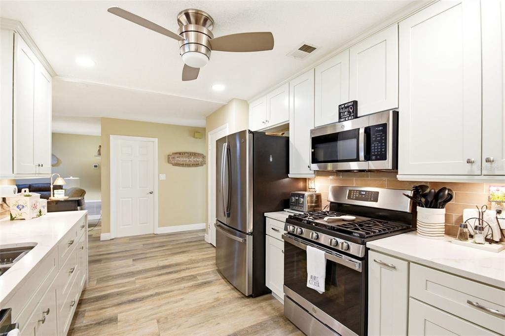 2636 Talbot Road Fern Park, FL 32730 - Photo 16 of 47 a kitchen with stainless steel appliances a stove microwave and refrigerator