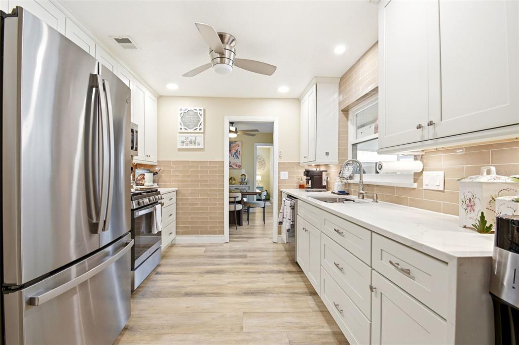 2636 Talbot Road Fern Park, FL 32730 - Photo 17 of 47 a kitchen with stainless steel appliances a refrigerator sink and cabinets