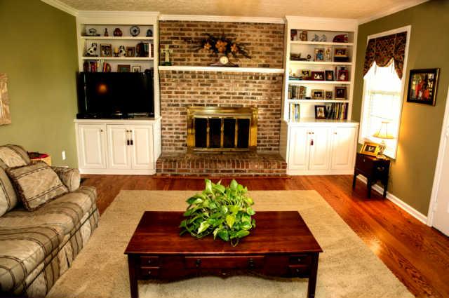 101 Gowen Road Manchester, TN 37355 - Photo 7 of 19 Relax by the Wood Burning Fireplace! This Living Room features Custom Built-ins and an Entry to the Back Patio.