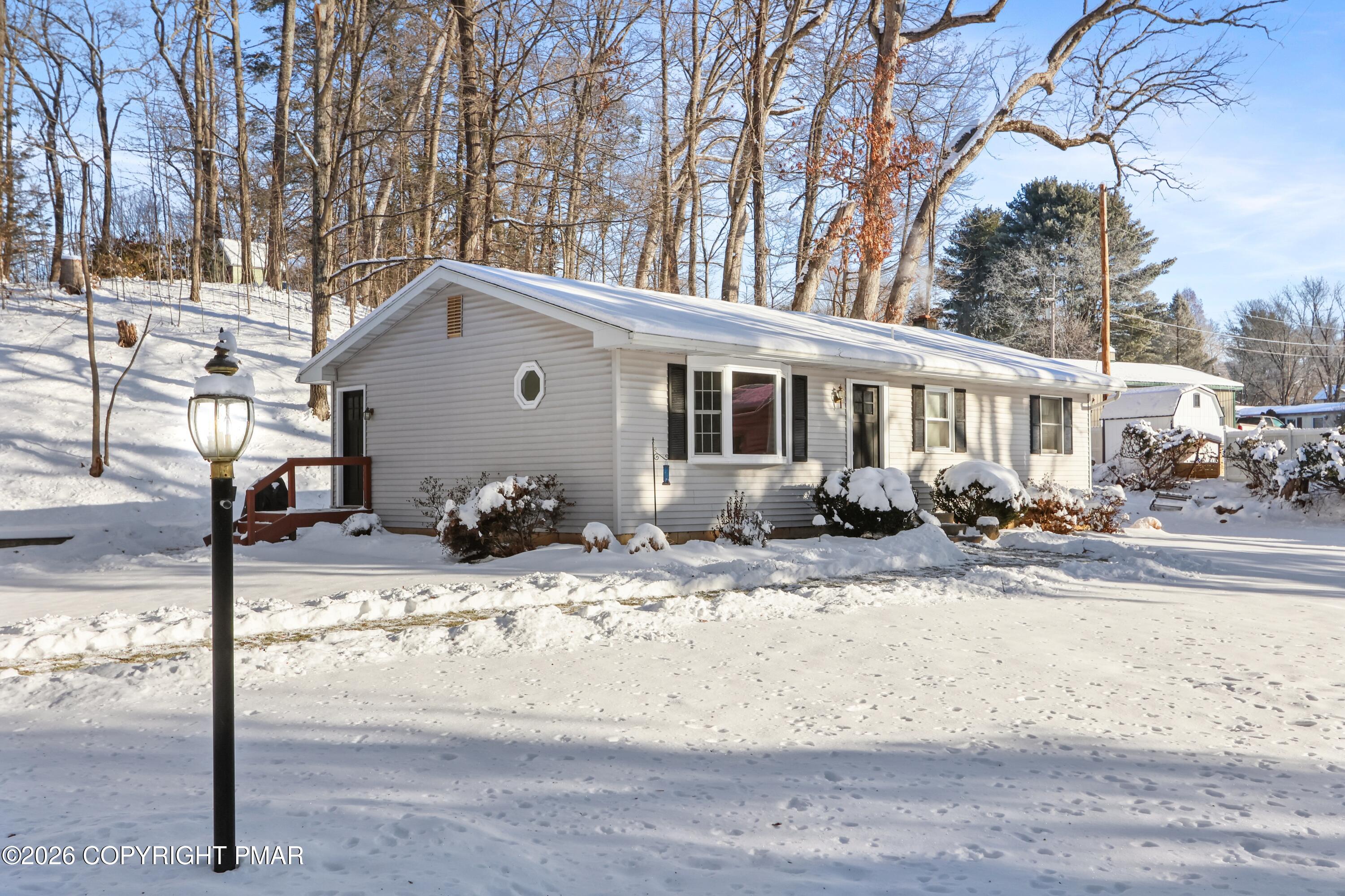 115 Clubhouse Road Saylorsburg, PA 18353 - Photo 3 of 3 a view of a house with snow on the road