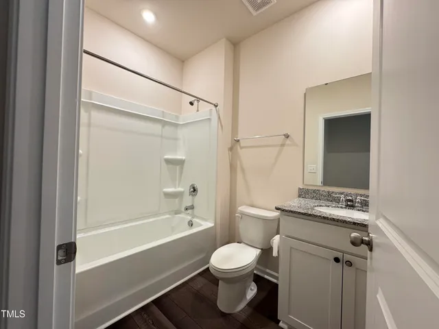 a bathroom with a toilet sink and shower
