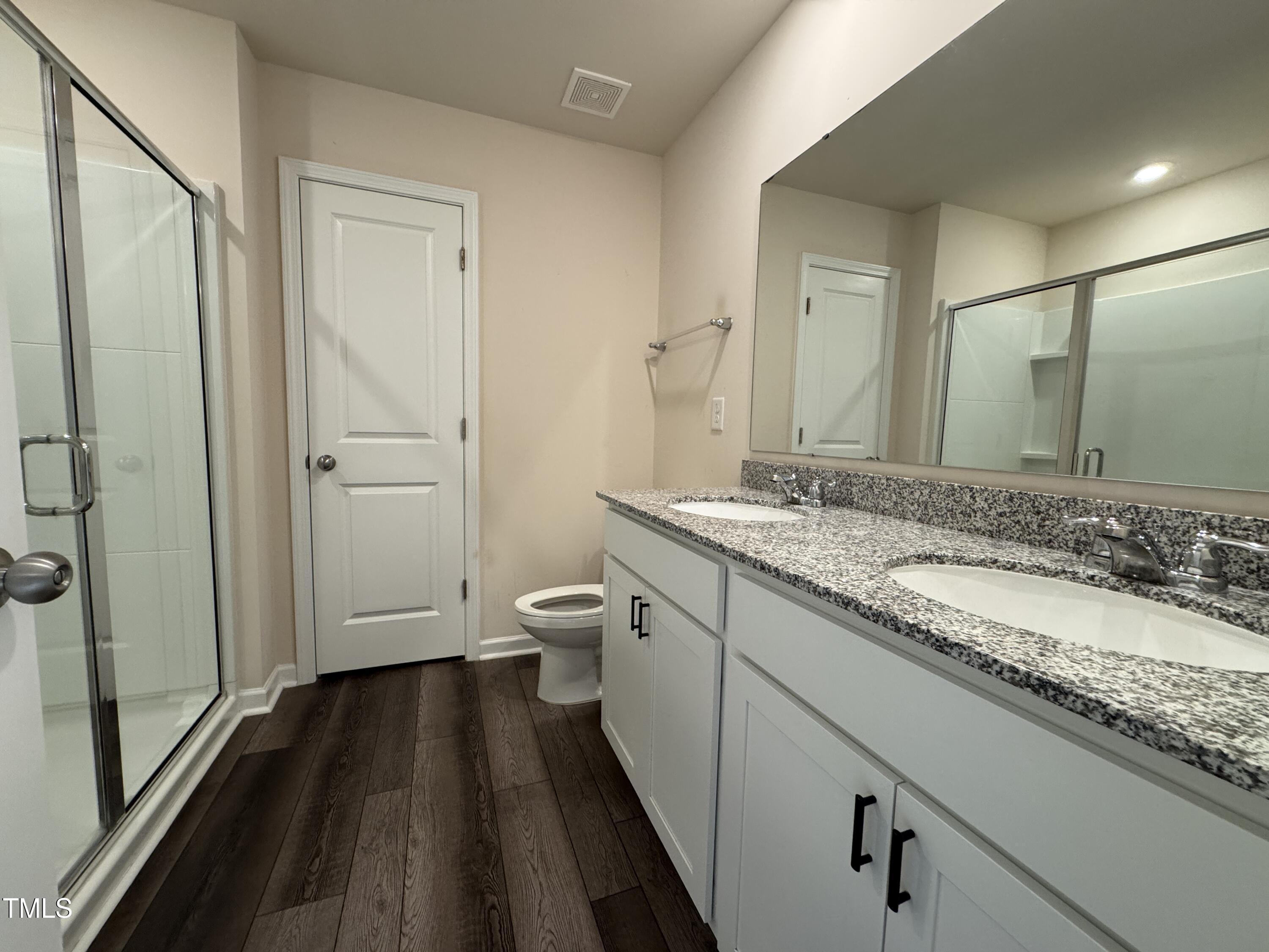 1413 Justice Union Court Raleigh, NC 27604 - Photo 26 of 29 a bathroom with a granite countertop sink toilet and shower
