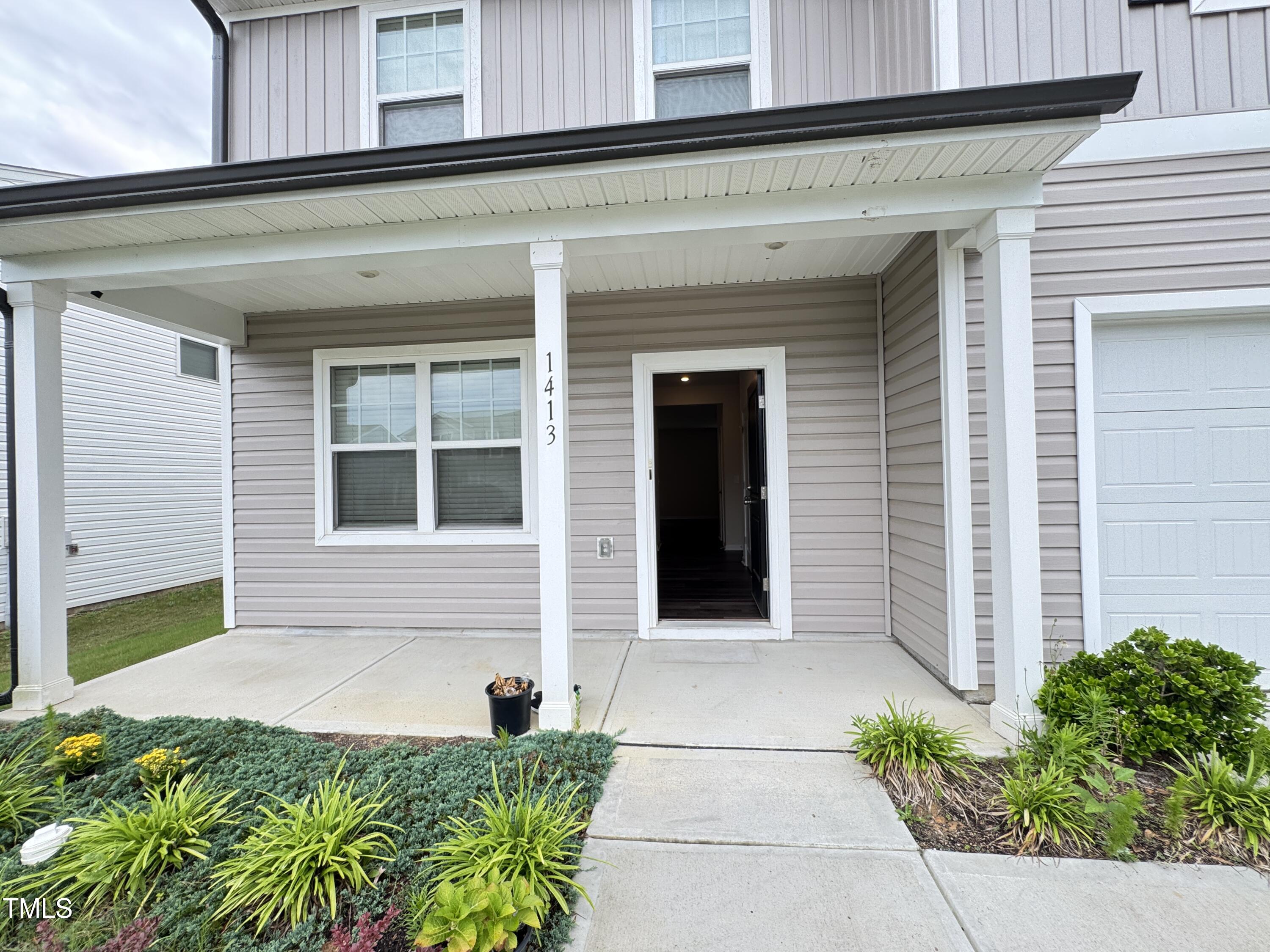 1413 Justice Union Court Raleigh, NC 27604 - Photo 3 of 29 a front view of a house with a yard