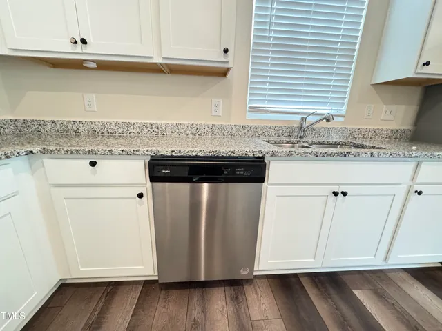 a kitchen with granite countertop cabinets and white appliances