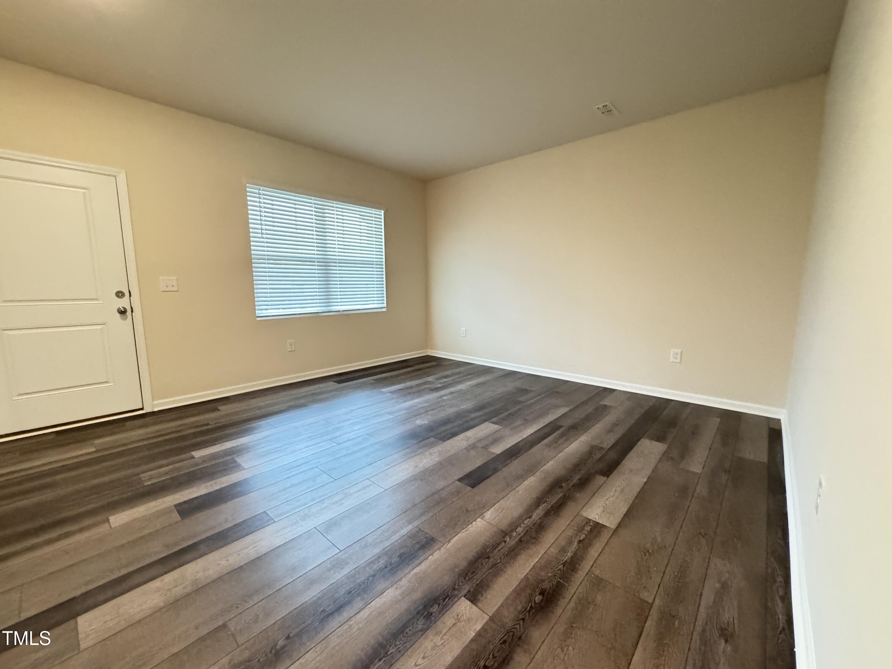 1413 Justice Union Court Raleigh, NC 27604 - Photo 10 of 29 a view of a room with wooden floor and window