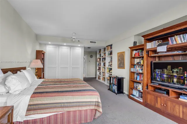 a large white bathroom with a sink a toilet a mirror and shower