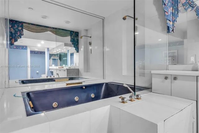 a large white kitchen with a sink and dishwasher a stove with wooden floor