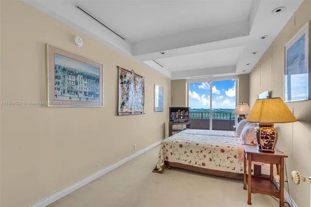 a living room with furniture a fireplace and a large window