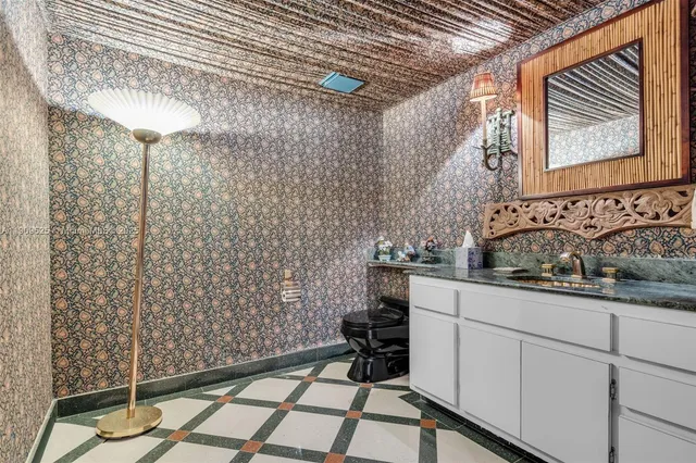 a bathroom with a double vanity sink toilet and shower