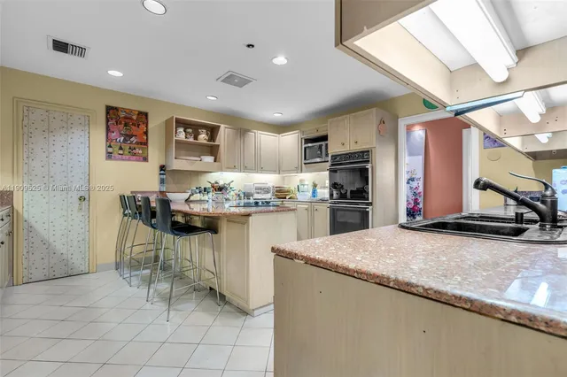 a kitchen with stainless steel appliances granite countertop a sink and cabinets