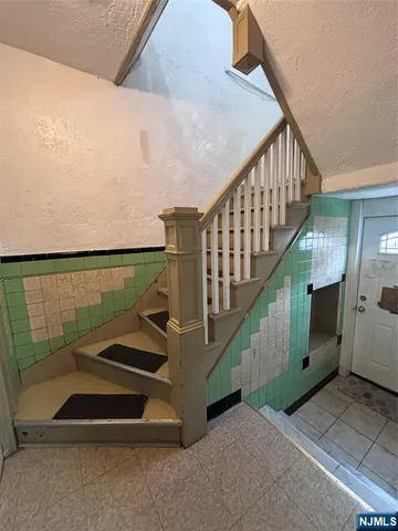 a bathroom with a granite countertop toilet sink and mirror