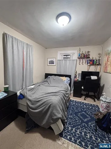 a bedroom with a bed and a chair