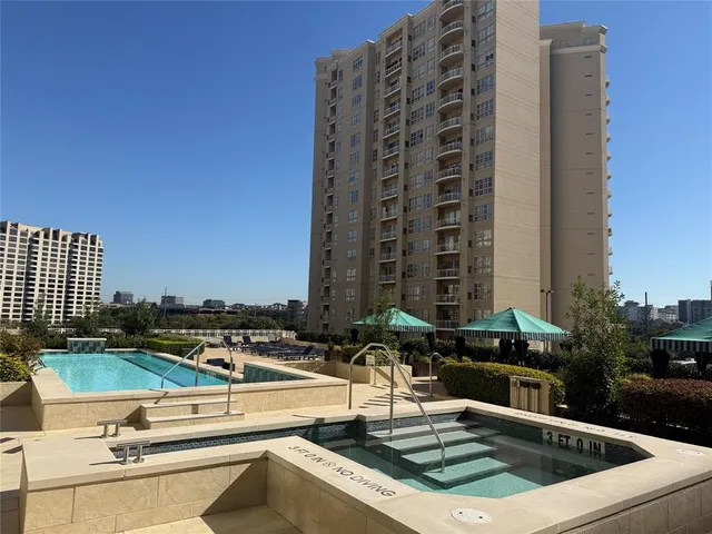 a view of a swimming pool with outdoor seating