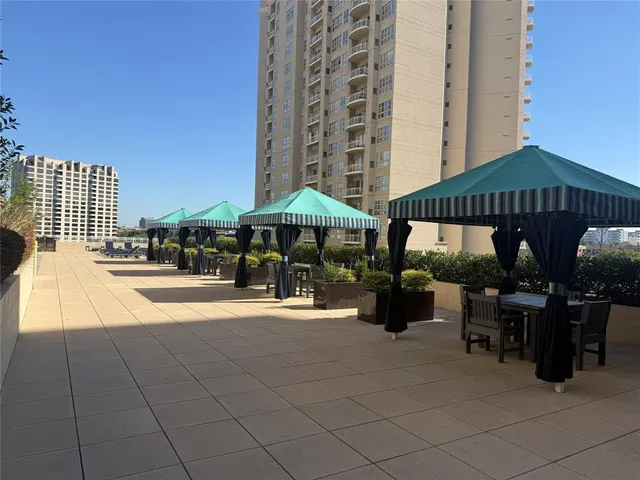 a view of a patio with a table and chairs under an umbrella