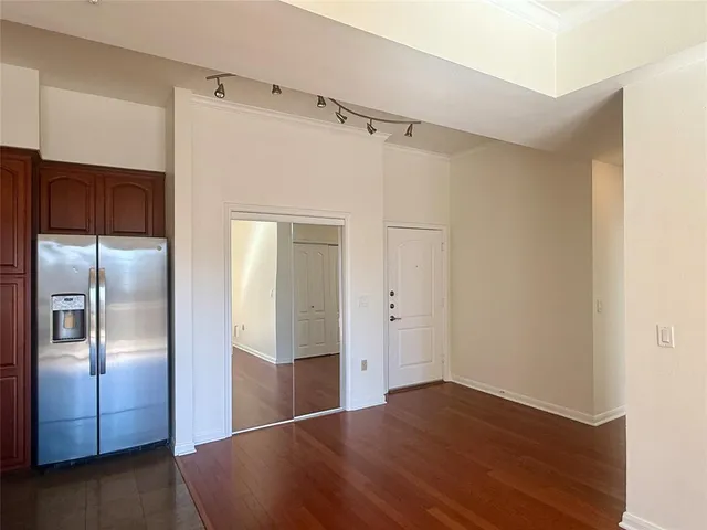 a view of a refrigerator in kitchen and wooden floor
