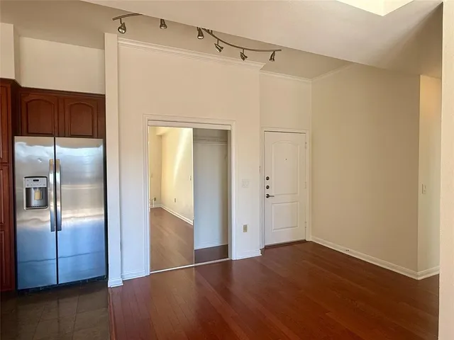 a view of a refrigerator in kitchen and wooden floor