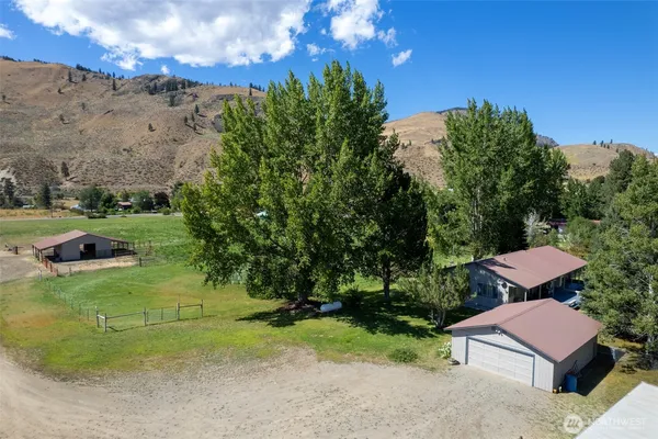 a view of a yard with swimming pool and trees