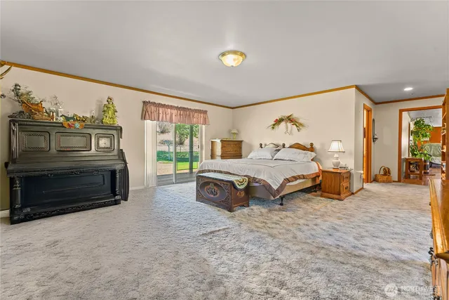 a spacious bedroom with a bed and a large window